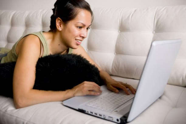 istock pretty girl on white couch with laptop (close up) 172289839