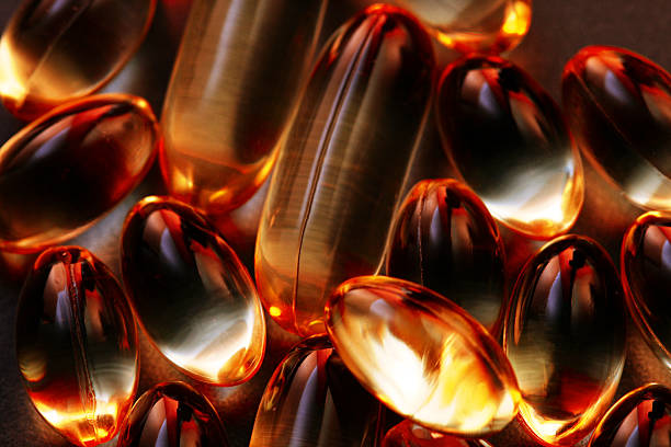 fundo de vitaminas - gel effect capsule pill vitamin e - fotografias e filmes do acervo