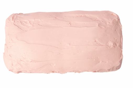 Sheet cake with pink frosting isolated on white