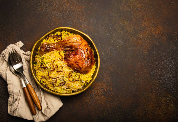 istock Indian dish Biryani chicken with basmati rice in metal brass old bowl on table 1722901314