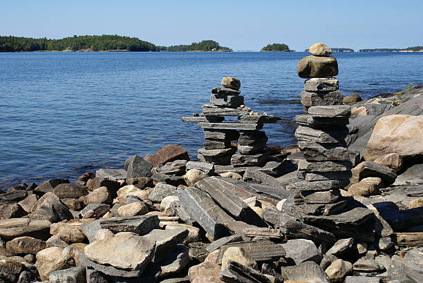 Northern Inukshuk A pair of Inukshuk in northern Canadian Landscape. Photo taken at Killbear Provincial Park in Ontario Canada. northern ontario stock pictures, royalty-free photos & images
