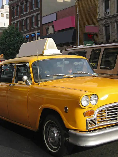 "1950s yellow taxicab on the streets of Manhattan, New York City, New York, USA."