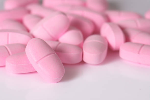 istock women's health - pink pills 172291566