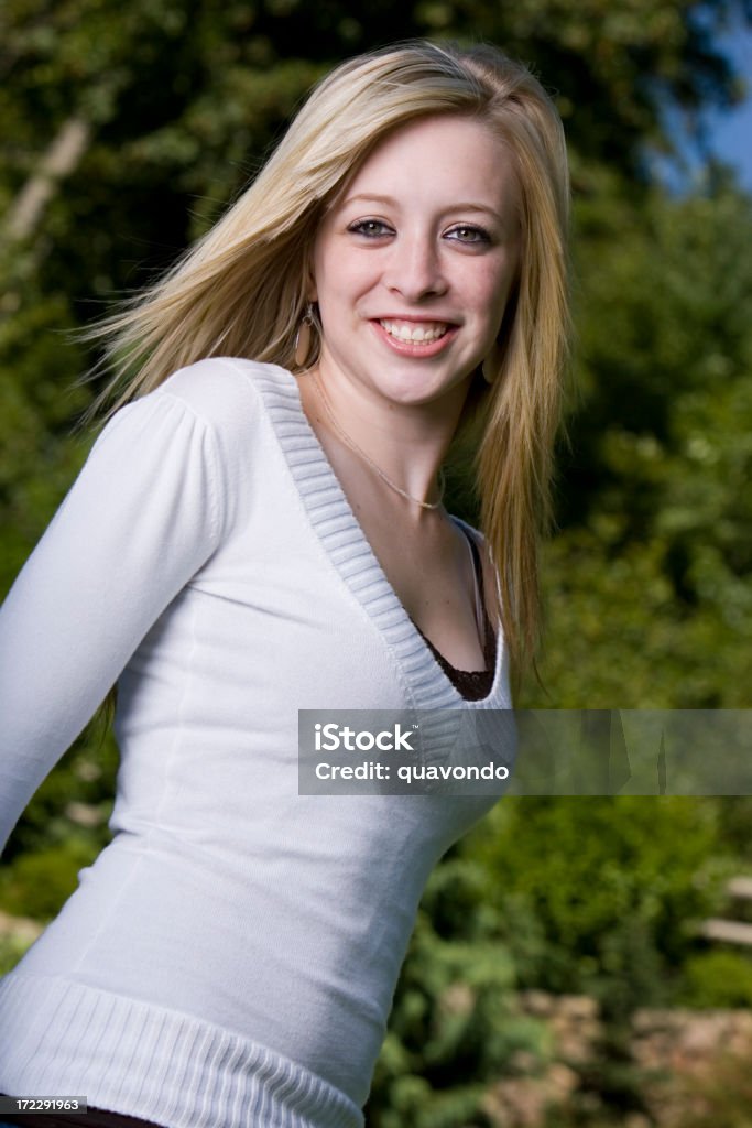 Beautiful Blond Teenage Girl Smiling Portrait, Copy Space Beautiful teenage girl smiling outside with wind blowing through hair. CLICK FOR SIMILAR IMAGES OR LIGHTBOX WITH BEAUTIFUL WOMEN. 16-17 Years Stock Photo