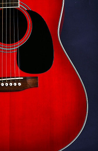 Acoustic cutaway guitar isolated over white background.