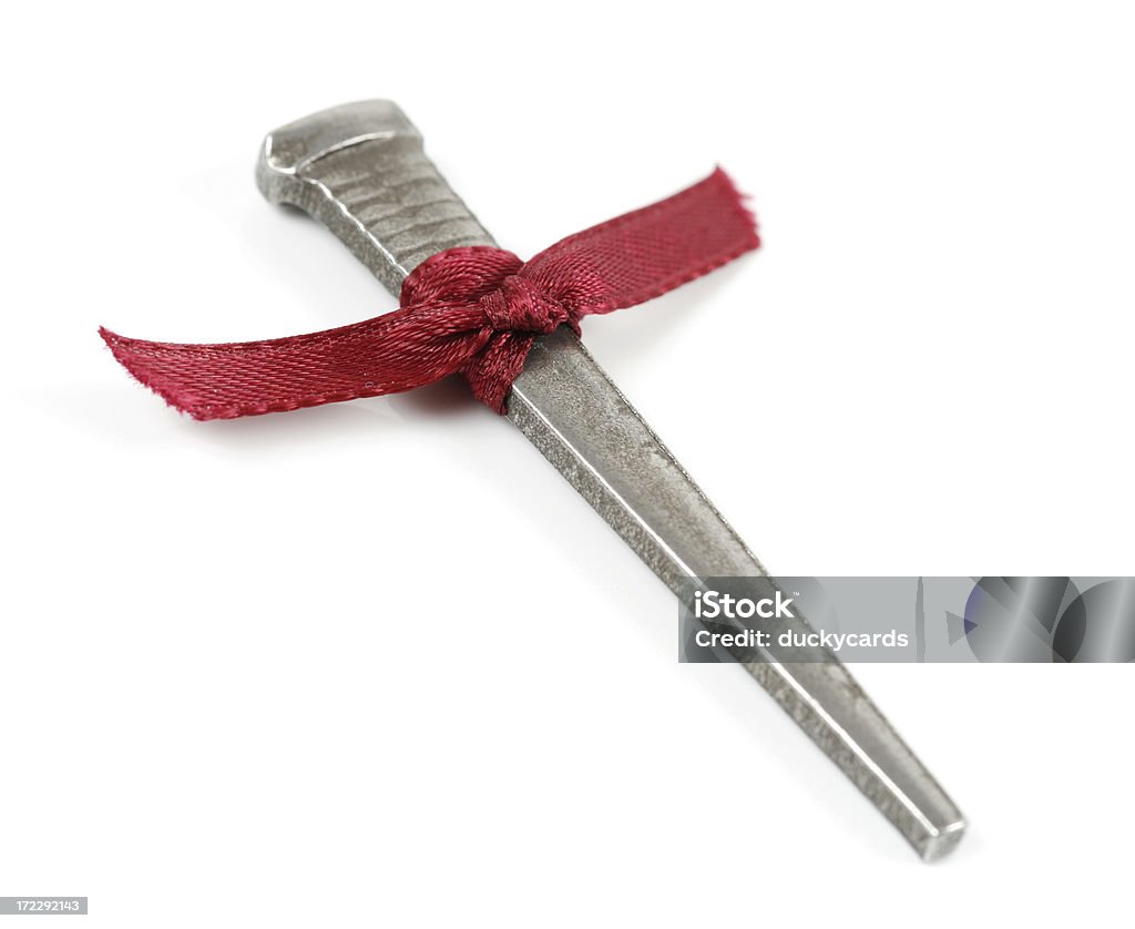 Nail with Ribbon A nail or spike. Could be used to symbolize the death of Christ. Focus is on the center of the ribbon. Christianity Stock Photo