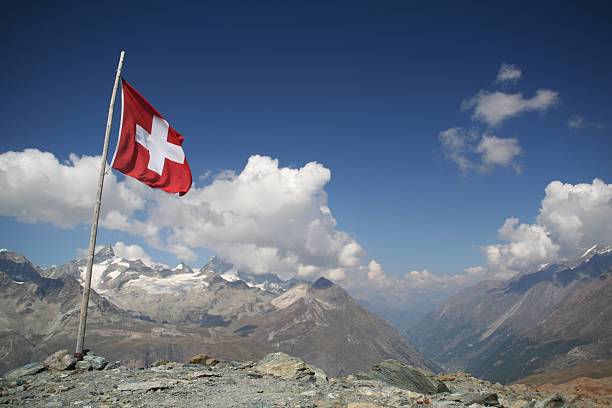 istock Swiss Flag Flying and Mountain Landscape 172292237