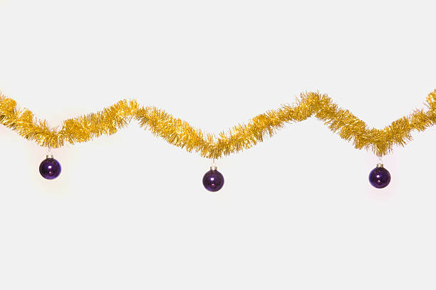 Garland Christmas decorations hanging with purple ornaments stock photo