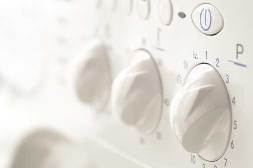 Close-up of programmer in the washing machine, knobs, buttons.