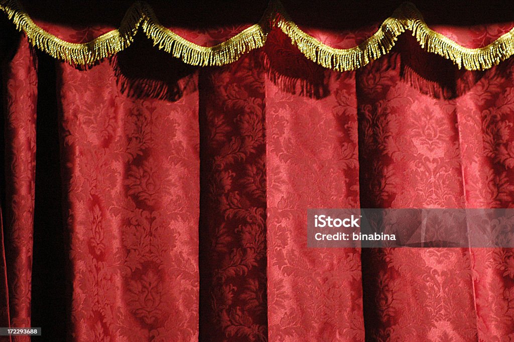 Close-up of a theater's red curtain with gold accents theatre red curtain Puppet Show Stock Photo
