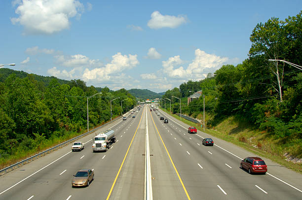 Six-lane interstate highway with cars and trucks