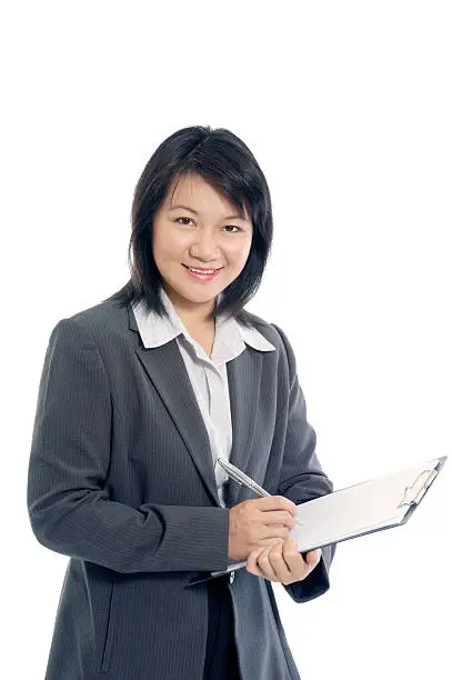 Portriat of a businesswoman taking notes over white background.