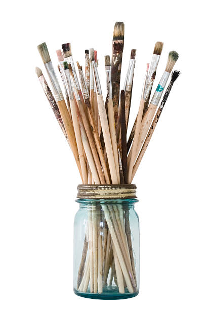 Picture of a clear jar filled with paint brushes
