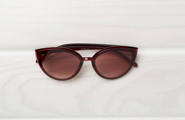 istock Sunglasses on wooden background, top view. 1722961688
