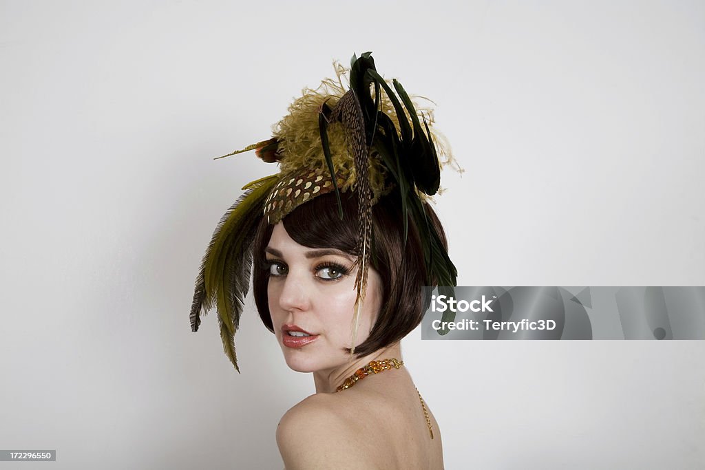 Glamorous Smiling Woman with Fancy Retro Feathered Hat Looking over her shoulder Adult Stock Photo