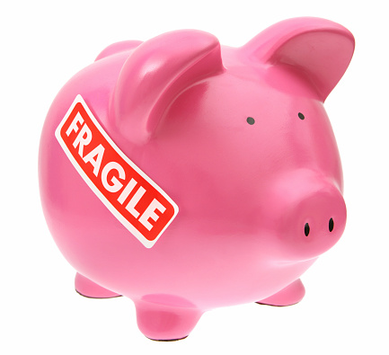 Piggy bank with fragile sticker on