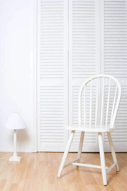 White chair and louvered doors