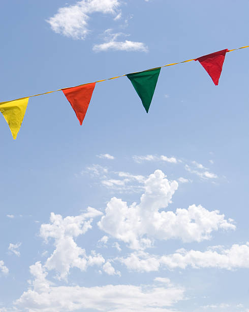 Colorful Festive Flags and Blue Sky with White Clouds