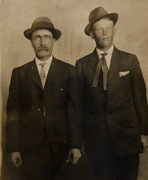 An antique (1800s) sepia photo of two men wearing suits and hats.  There are some minor scratches and a bit of grunge -- but that adds to the vintage look.  See my portfolio for more vintage photos and ephemera.  More coming soon.  I'd love to see how you use my images -- send me a note!