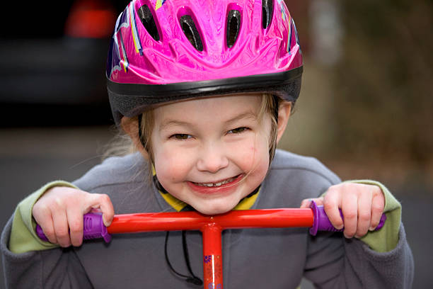 istock Young Girl with Helmet on a scooter 172298294