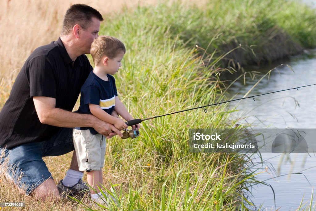 Pais ajudando o filho de peixe - Foto de stock de Adulto royalty-free