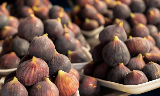 Figs, a pile of purple figs on stall in the farmer's market. Selective Focus.
