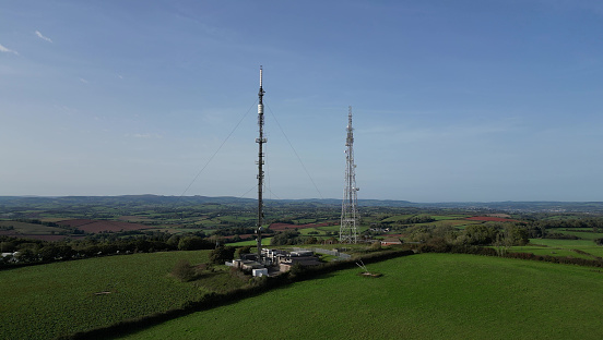 The drone shows the twin radio (right) and television (left) transmission towers as well as the beautiful Devon countryside, including farm fields, in the background. 
The radio transmitter is known as Beacon Hill A and the television transmitter tower is known as Beacon Hill B.
In April 2009, the analogue television transmissions at Beacon Hill A were turned off, requiring homes in the area to switch to the Freeview service. The Beacon Hill transmitter group was the first in the South West of England to stop broadcasting analogue television services.
The Torbay area of Devon is a popular UK holiday area and tourist destination.