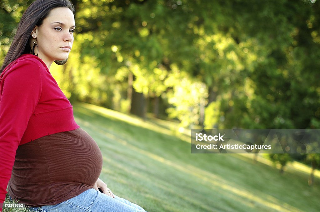 Contemplating "Fashionable, pregnant teenager in deep thought. Composed with room for text on right." Pregnant Stock Photo