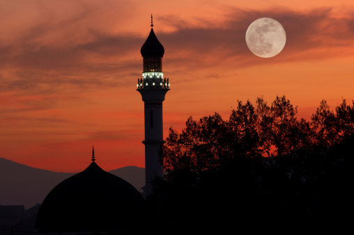 mosque at dusk with full moon