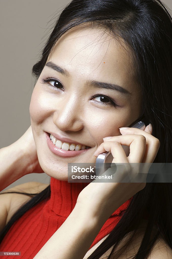 Asiática modelo sonriendo en el teléfono - Foto de stock de Etnia coreana libre de derechos