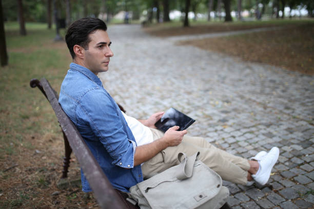 istock Using laptop at the park stock photo 1723008120