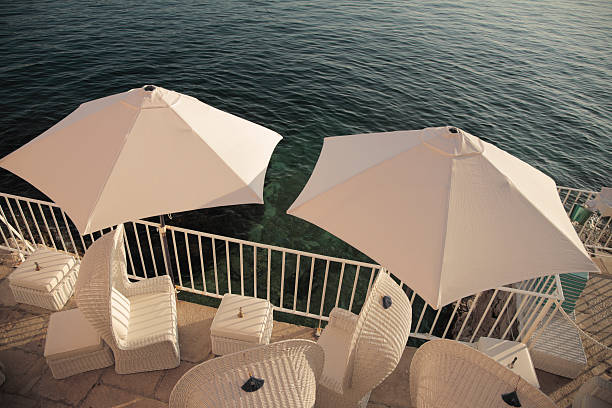 istock Balcony view with wicker chairs and linen umbrellas. 172300819