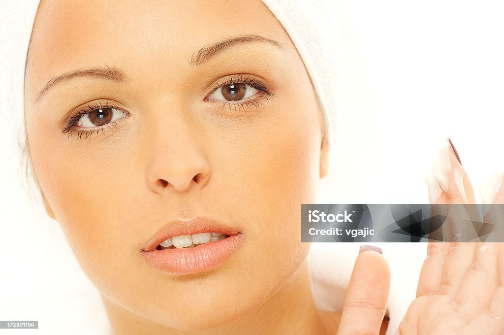Cosmetic girls Closeup of young attractive girl applying daily care cream Activity Stock Photo