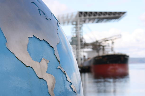 Global Cargo Shipping Concept A globe with focus on the United States (USA) and Central America contrsted against a blurred background of a bulk cargo ship exemplifying the global nature of the cargo industry. Look at more tariff stock pictures, royalty-free photos & images