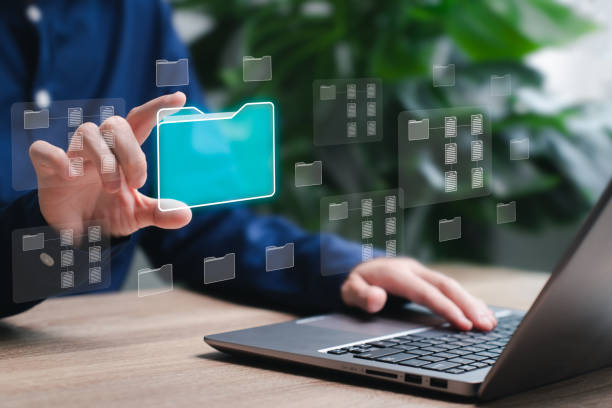 istock Document folder management system concept, Businesswomen use laptop show digital folder in hand document management and modern technology Software for archiving, searching and managing corporate file 1723019261