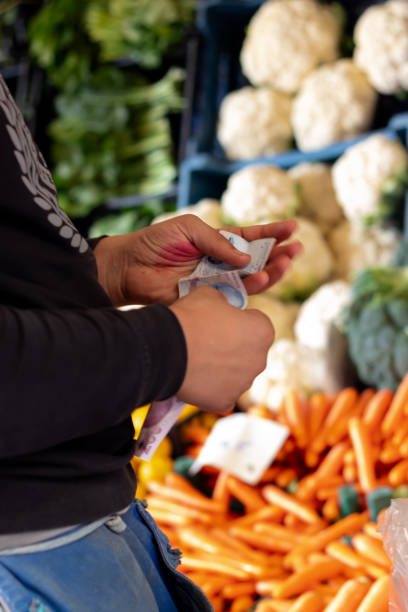 istock Vegetable Vendor and Money 1723022809