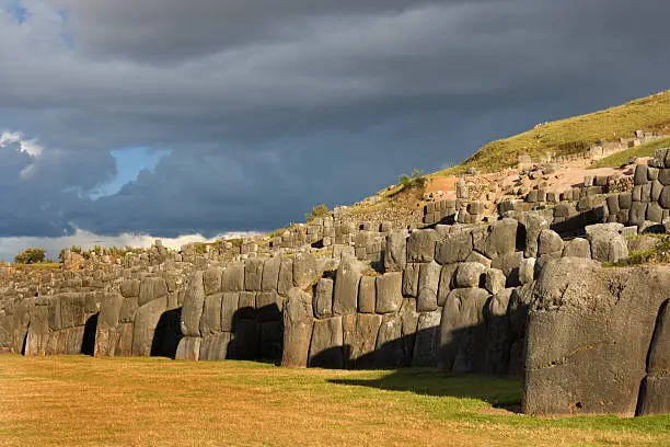 "Subject: Horizontal view of the SacsayhuamA!n stone walls, at dusk on a stormy dayLocation: Near Cuzco, Peru"