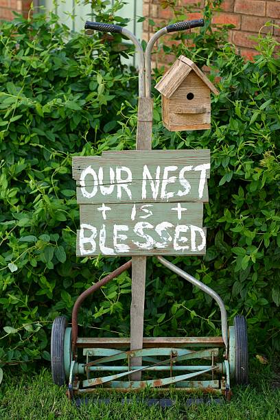 istock Blessed Nest: old push mower with sign and birdhouse 172304027