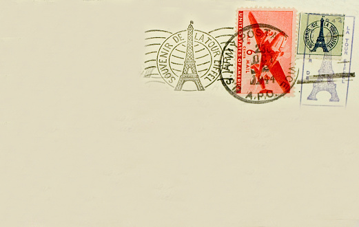 A World War II 1944 Eiffel Tower souvenir postcard with icons of tower and US Army APO postmark.