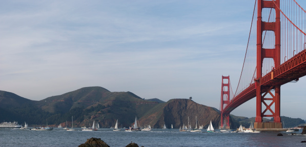 Numerous boats in front of Marin Headlands awaiting the ocean liner Queen Mary 2. This is a seamlessly stitched panoramic.