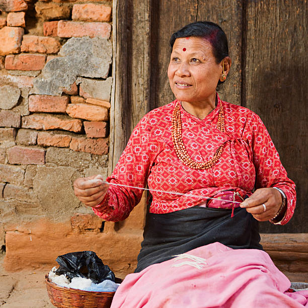 istock Nepali woman spinning the wool 172304612