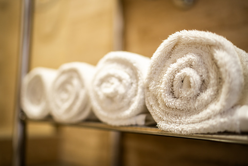 Close-up of a rolled towels on the shelf at the home