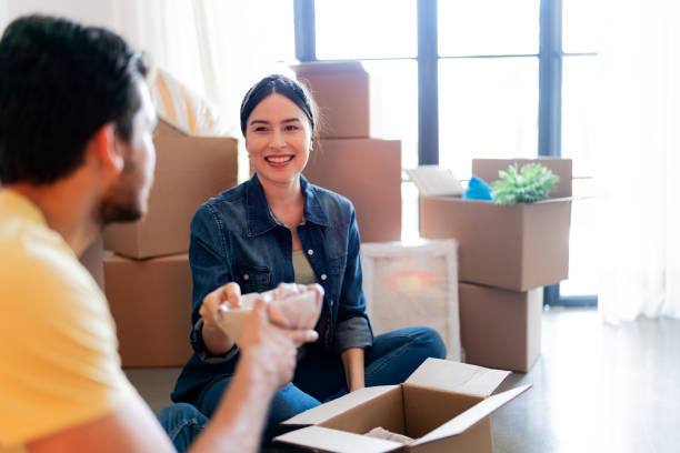 istock Young couple unpacking moving boxes at the new home 1723049736