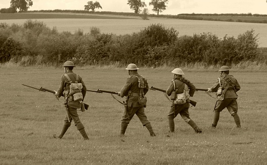 Sepia photo of WWII American soldiers in combat
