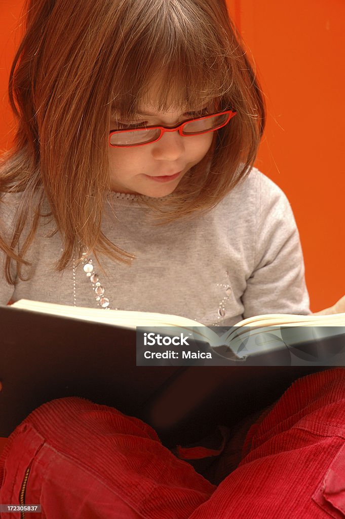 Little reader in red. Five years old.More of this model and theme at:Books and book lovers lightbox: Number 5 Stock Photo
