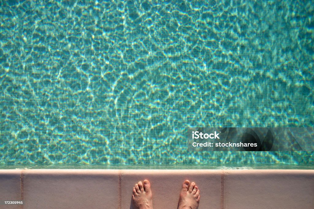 Swimming Pool and Feet Swimming Pool with Man's Feet on the Poolside Adult Stock Photo