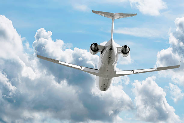 istock corporate jet airplane flying in cloudy sky 172306549