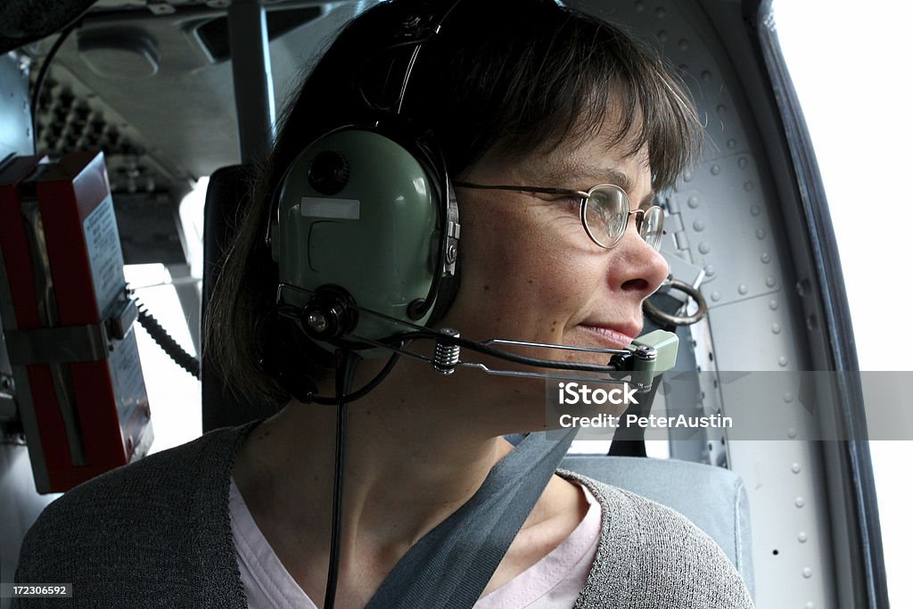 Admiring the View A relaxed helicopter passenger admiring the view. Helicopter Stock Photo