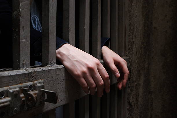 670+ Hands On Prison Bars Stock Photos, Pictures & Royalty ...