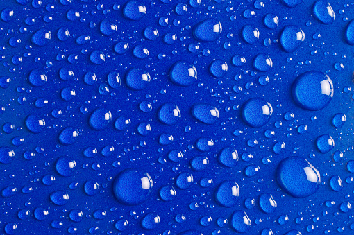 Water Drops on Blue Metallic Surface.